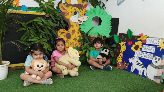 Children with stuffed animals in a classroom setting with educational decorations