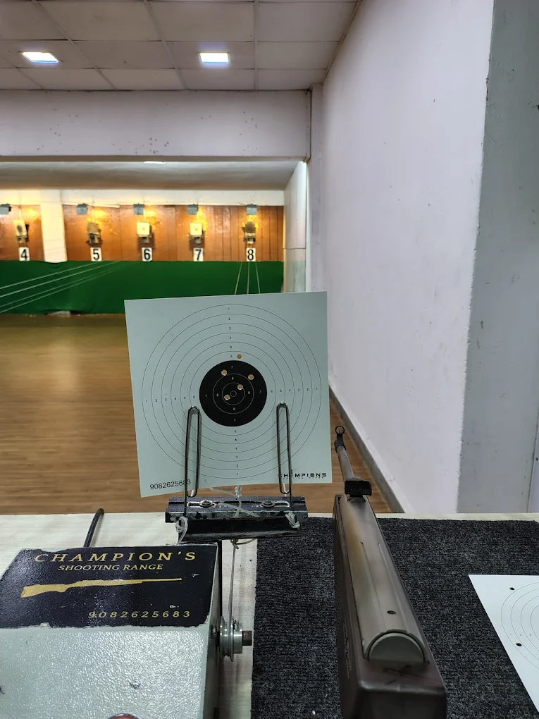 A rifle is aimed at a target in a shooting range.