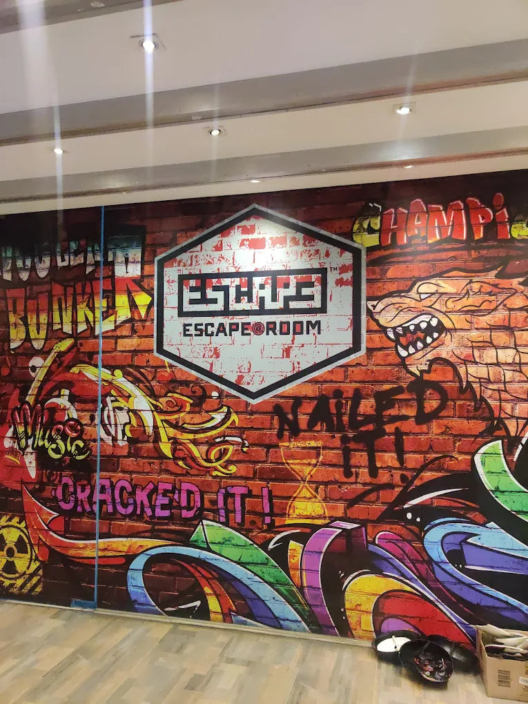 Graffiti-style mural for an escape room, featuring dragons and bold text.