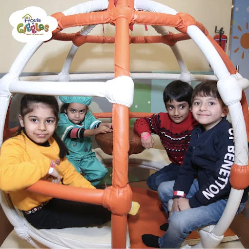 Four children sitting inside a soft play structure enjoying a creative activity session at House of Giggles Delhi