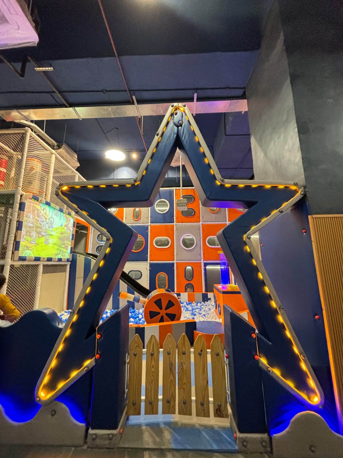 A star-shaped entrance to a children's indoor playground with a ball pit.