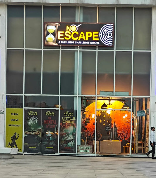 An escape room entrance with a spooky castle mural and posters for "The Casino Heist" and "The Mental Asylum."