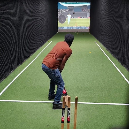 Person playing virtual cricket game in indoor net practice area at Smaaash Sector 68 Gurgaon New Year event