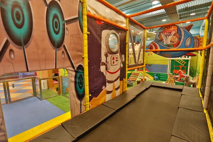 Indoor playzone featuring astronaut graphics and basketball hoop in vibrant Sector 104 Noida play area