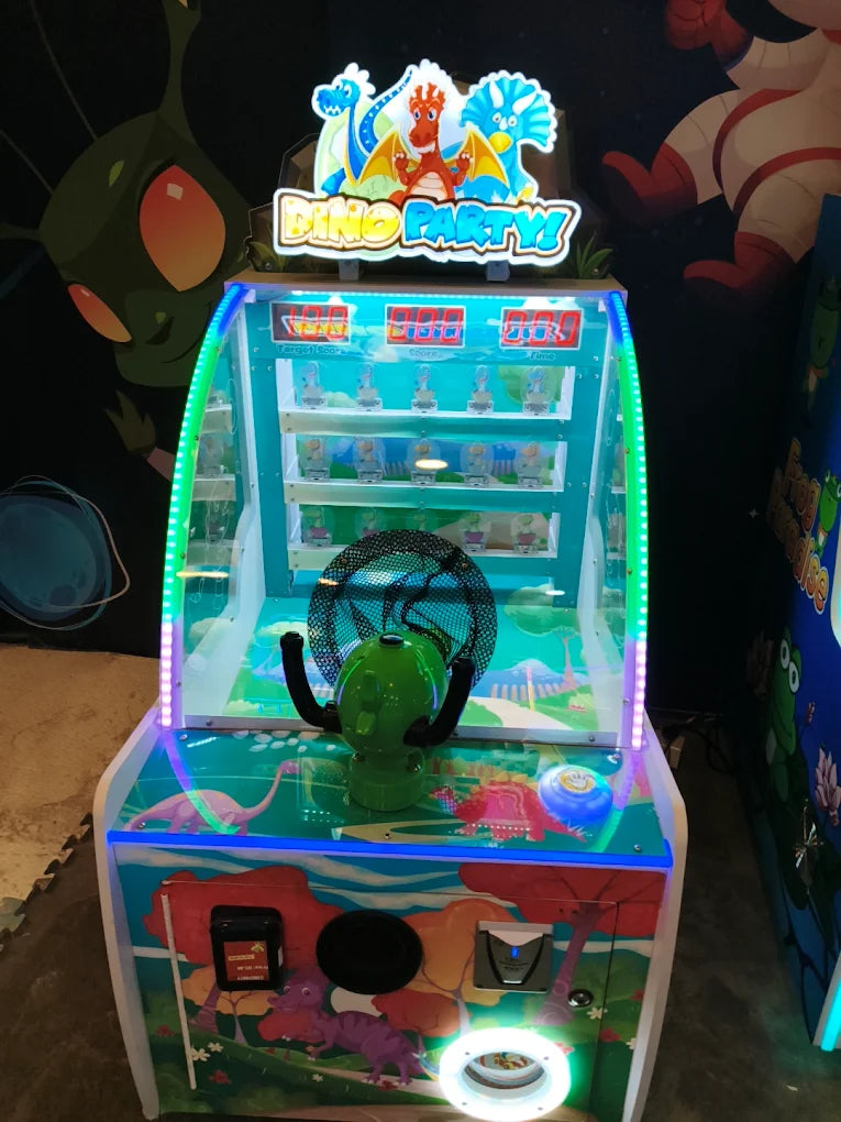 A "Dino Party" arcade game with a green fan and colorful dinosaur graphics.