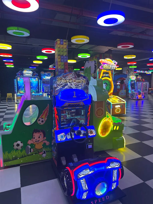 An arcade with colorful lights and racing games.