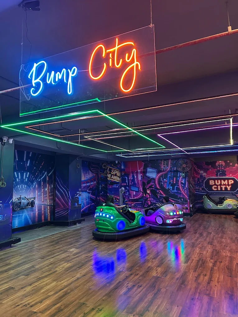 Bumper cars in a neon-lit arcade, with children enjoying the ride.