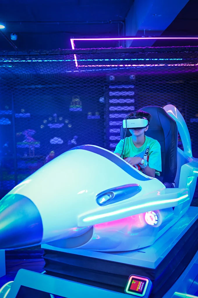 A child wearing a VR headset sits in a futuristic simulator, immersed in a neon-lit arcade.