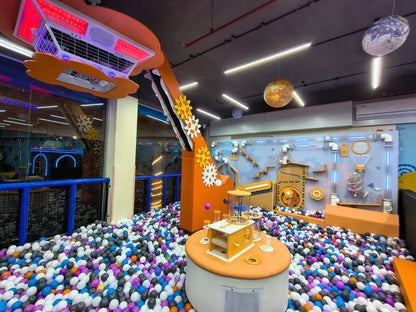 A colorful ball pit and interactive science exhibits for children in a playful indoor space.