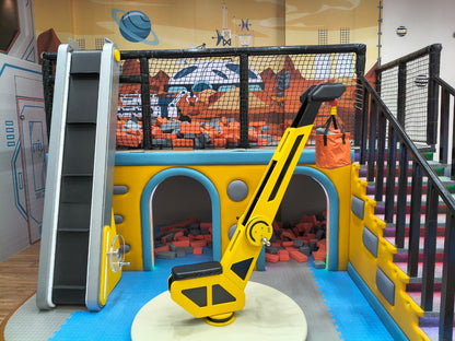 A colorful indoor playground with a slide, ball pit, and climbing structure for children.