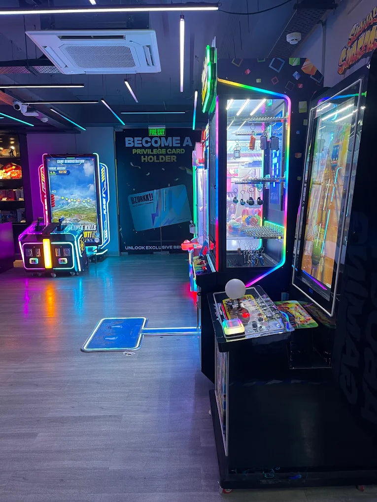 An arcade with glowing machines and a sign encouraging visitors to become privilege card holders.