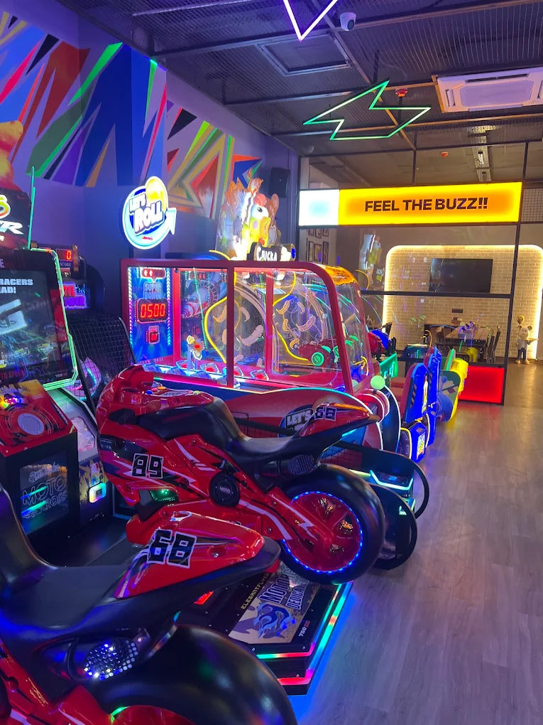 A vibrant arcade with motorcycle racing games and colorful lights.