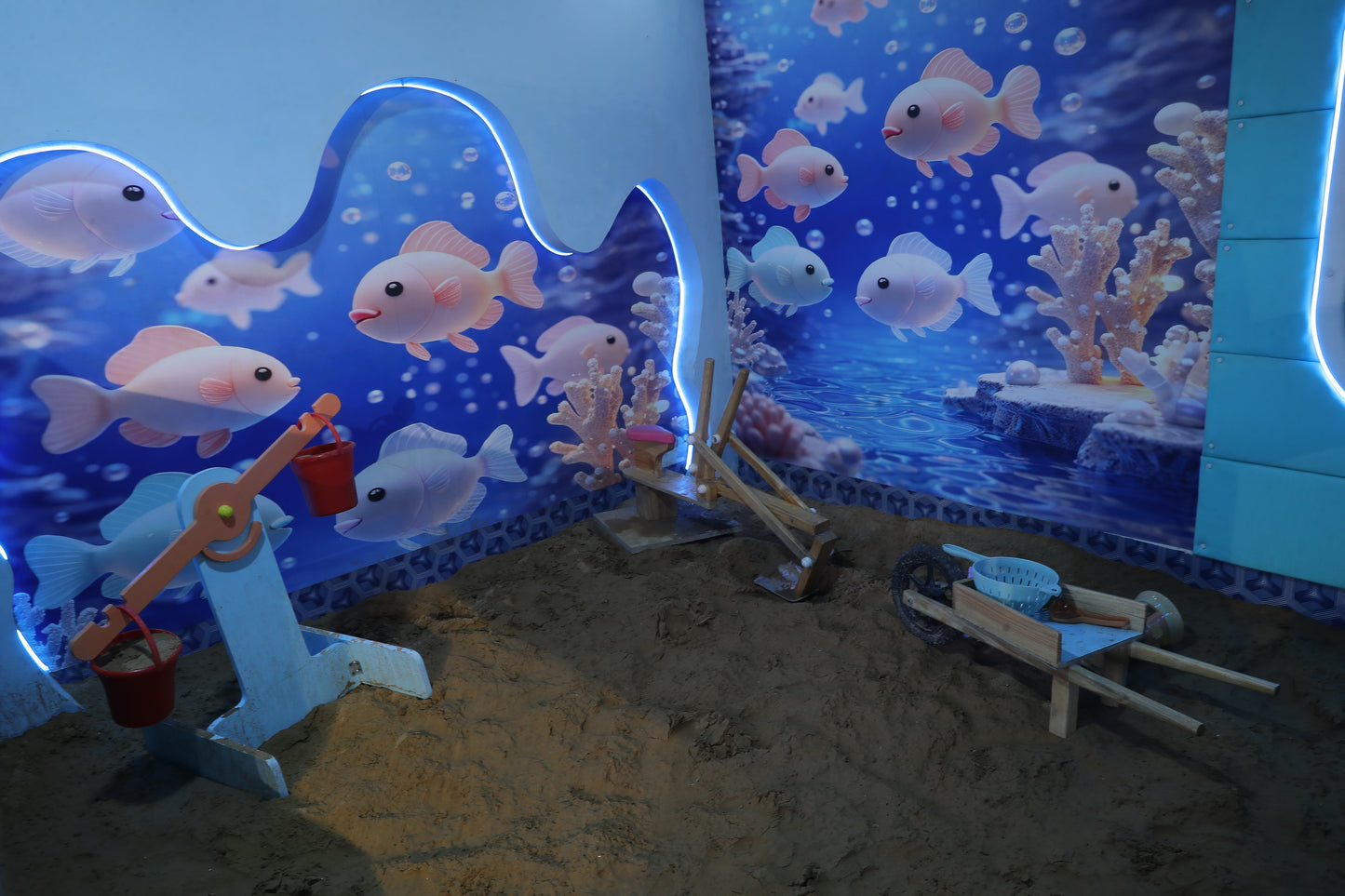 A playful underwater scene with cartoon fish and sand toys, possibly for children.