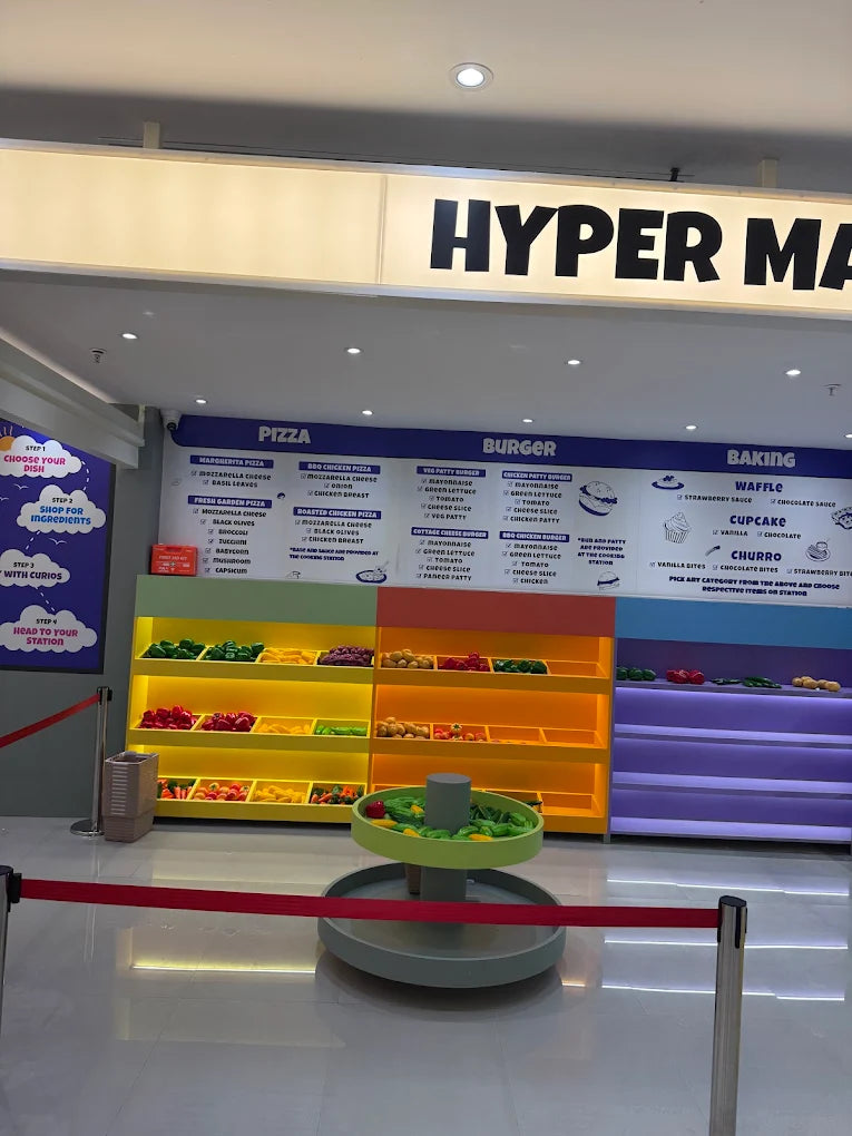 A food ordering station with colorful ingredient displays and a menu board.