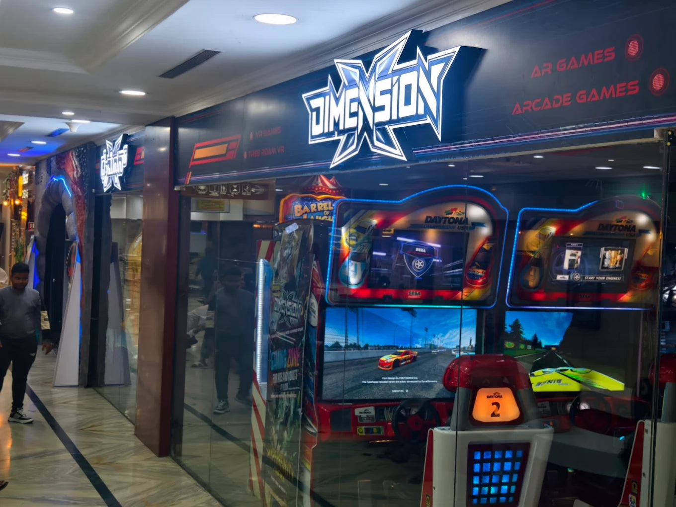 An arcade with racing game machines and a sign for "Dimension AR Games".