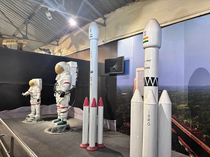 Models of astronauts and rockets on display at an exhibition.