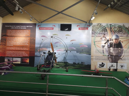Paramotoring and motorized paragliding display with a paramotor vehicle and paragliders in flight.