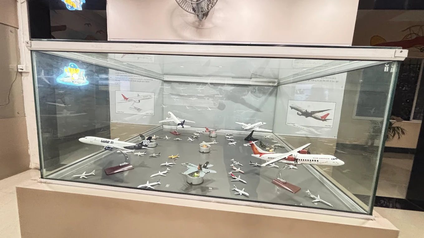 A display case filled with model airplanes, showcasing various aircraft designs.