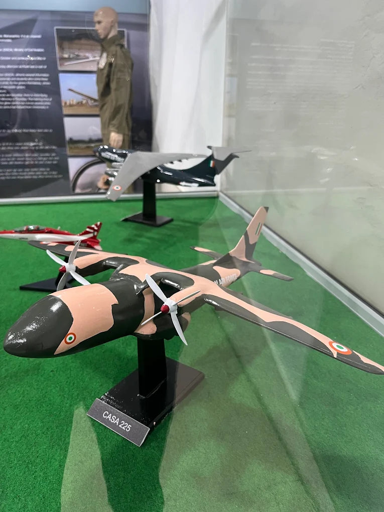 Model aircraft on display, including a CASA 225 with camouflage paint.