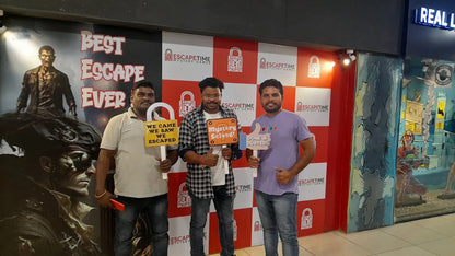 Three adult men pose with signs after completing an escape room at "Escape Time Mystery Games."