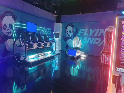 A VR experience with panda branding, featuring motion simulator seats and arcade games.