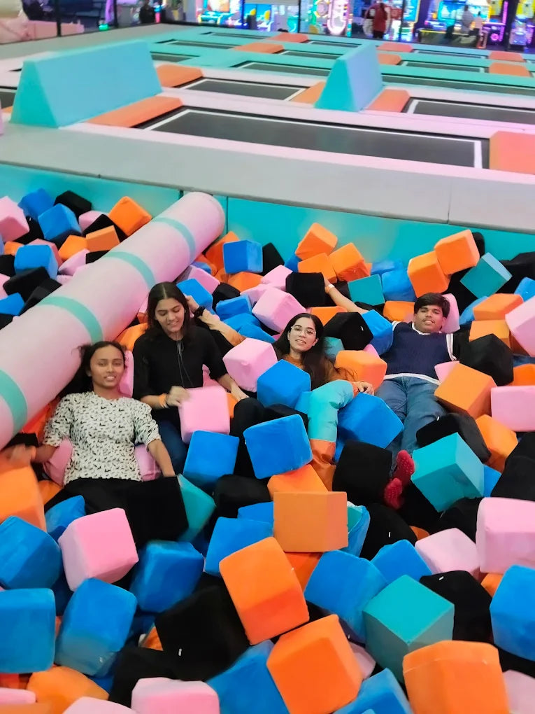 Young people in a foam pit at a trampoline park.
