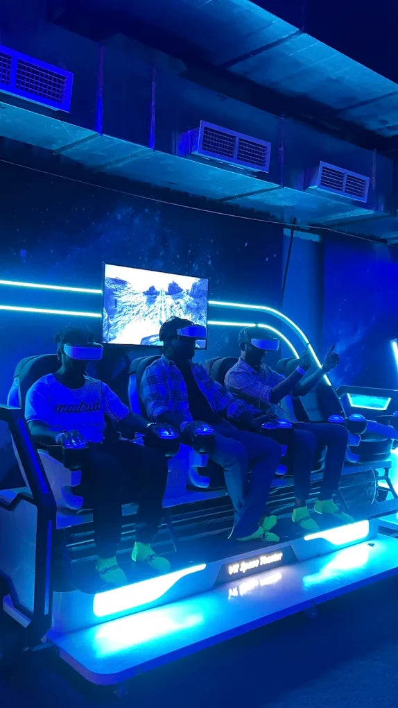 Young adults experience a VR simulation in a futuristic, neon-lit theater.