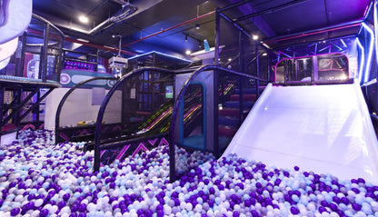 Children's play area with ball pit and slides in a indoor playground.