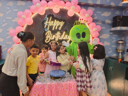 Children celebrating birthday party with green alien mascot and pink balloon arch at Fun Orbbit Kids Play Area Gujranwala Town Delhi