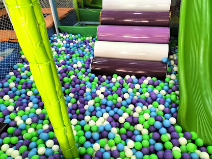 A ball pit filled with colorful balls and a green slide, suggesting a children's play area.