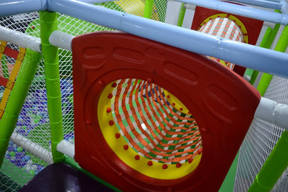 A colorful indoor playground with a red tunnel and a ball pit for children.