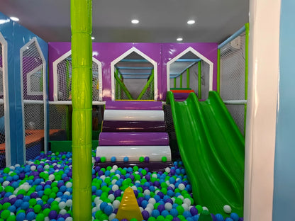 A colorful indoor playground with a ball pit, slides, and climbing structures for children.