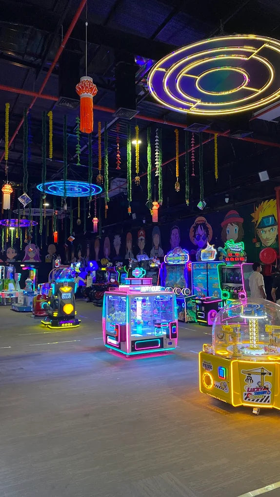 An arcade filled with colorful, glowing games and anime-inspired murals.