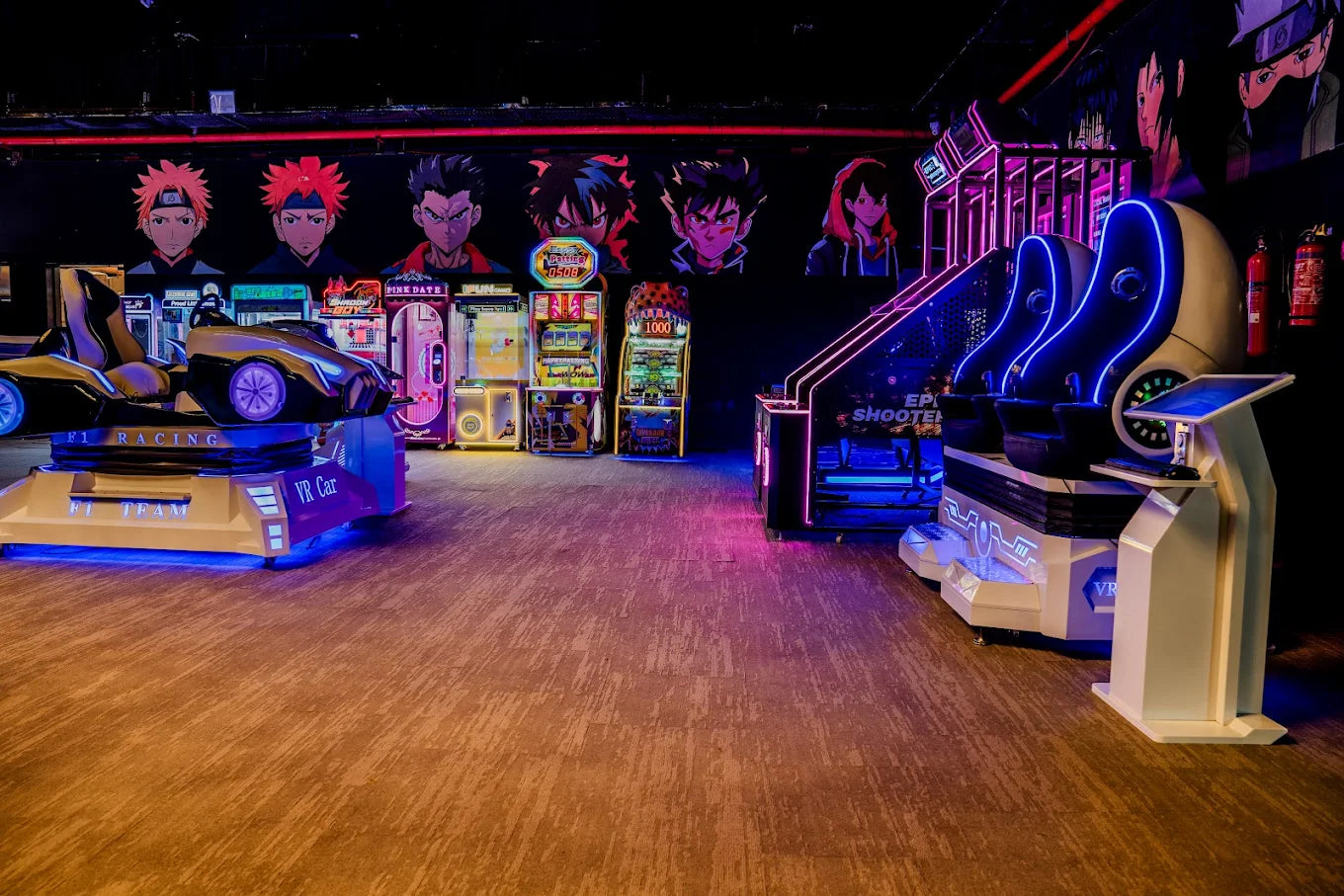An arcade with VR racing and shooting games, featuring anime-style characters on the wall.