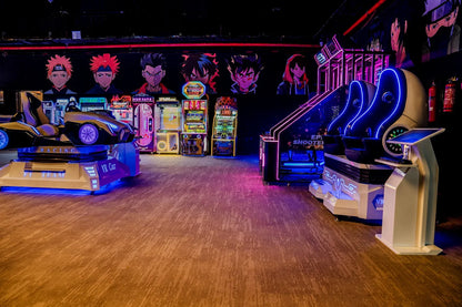 An arcade with VR racing and shooting games, featuring anime-style characters on the wall.