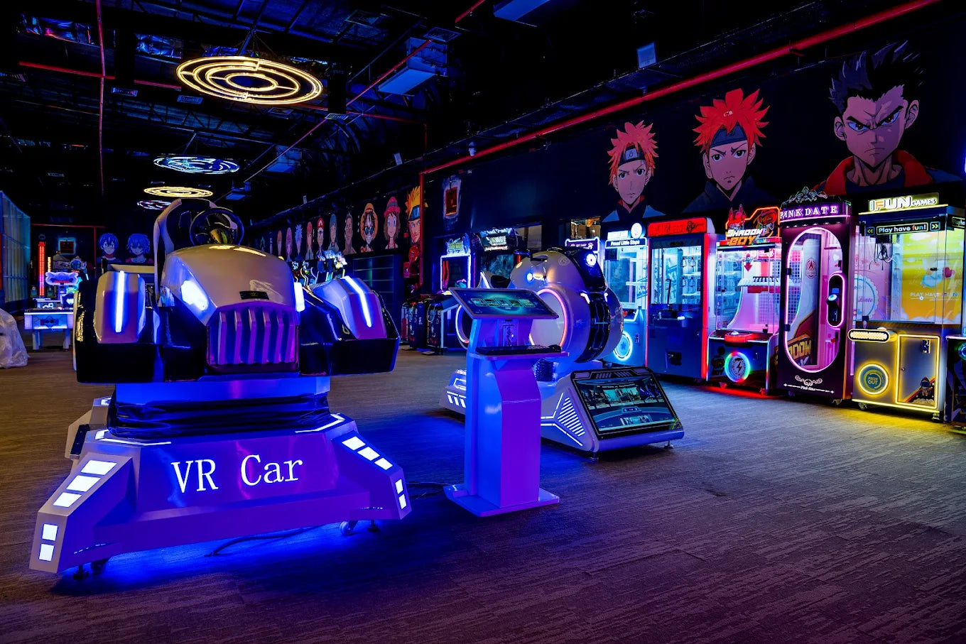 VR car and arcade games in a dimly lit entertainment center.