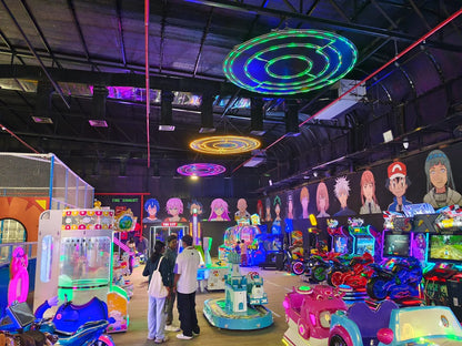 An arcade filled with anime characters, colorful games, and young adults.