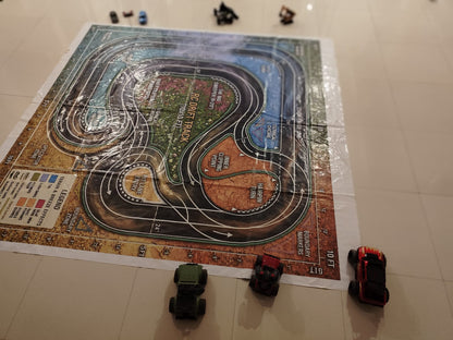 Toy cars race on a detailed RC drift track mat, with a legend and boundary markers visible.