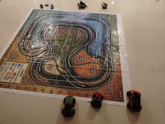 Toy cars race on a detailed RC drift track mat, with a legend and boundary markers visible.