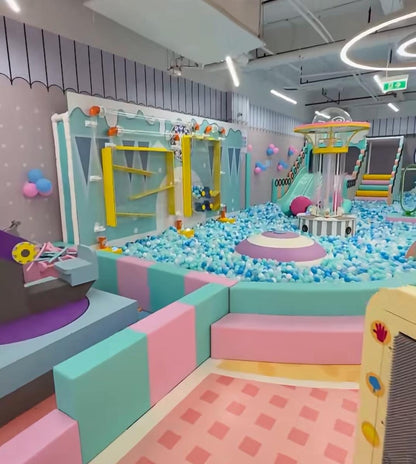 A colorful indoor playground with a ball pit, slides, and climbing structures for young children.