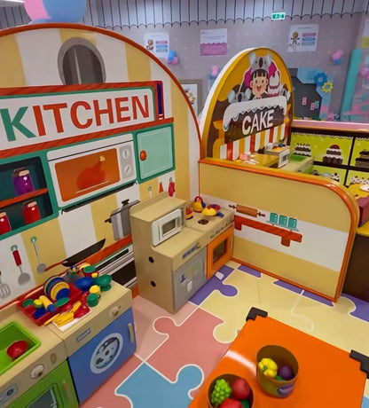 A colorful indoor play kitchen with toy appliances and food for young children.