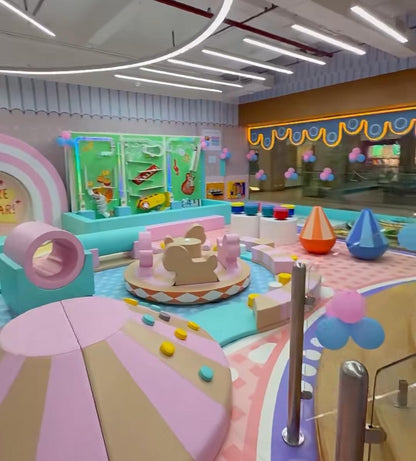 A colorful indoor playground for young children with soft play structures and interactive elements.