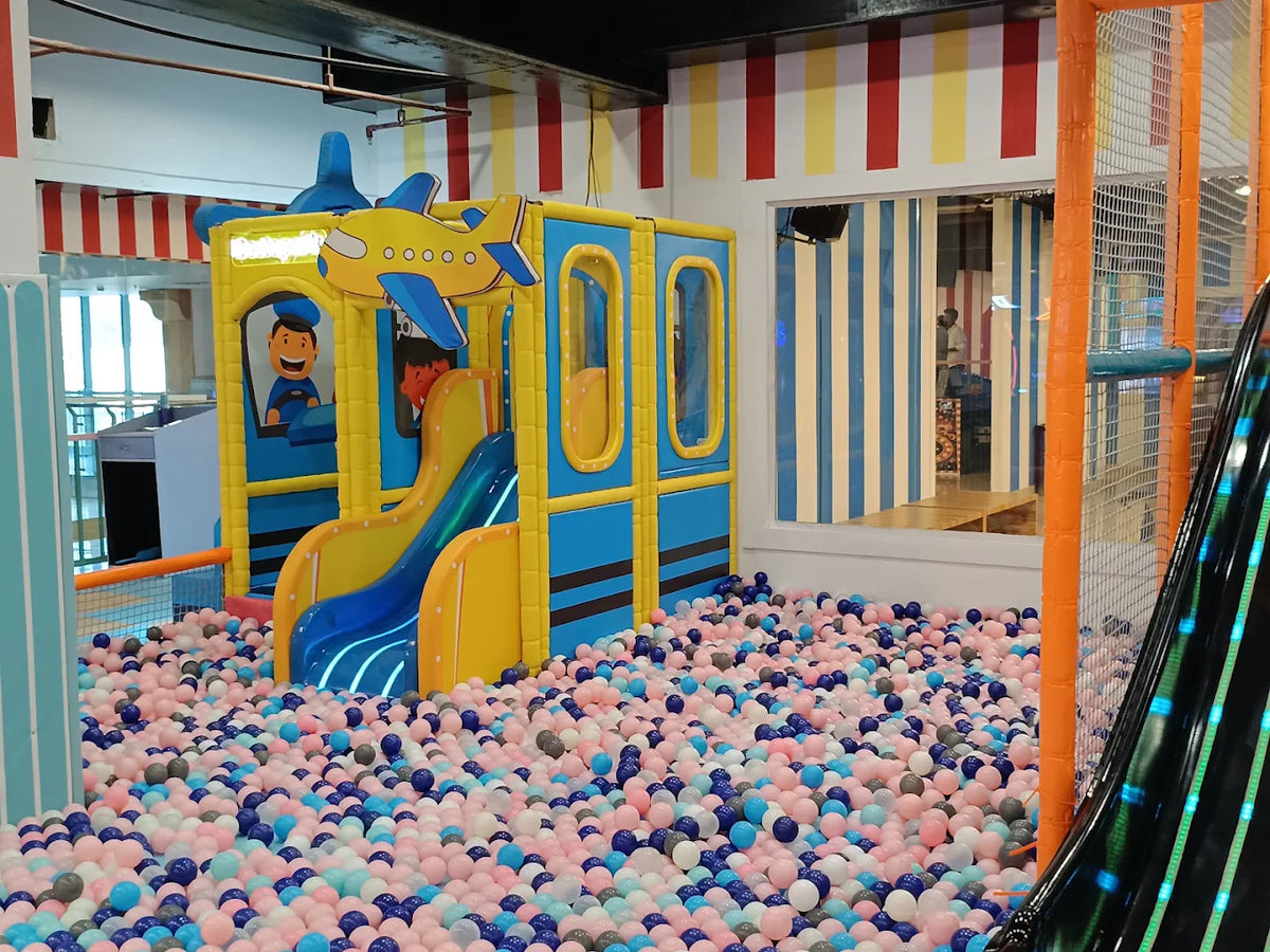 A colorful ball pit with a play structure for children.