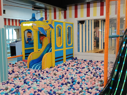 A colorful ball pit with a play structure for children.