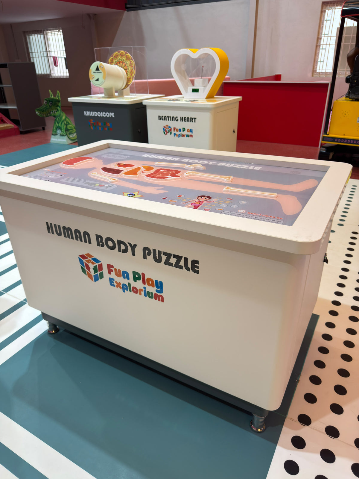 A human body puzzle on a table in a children's play area.