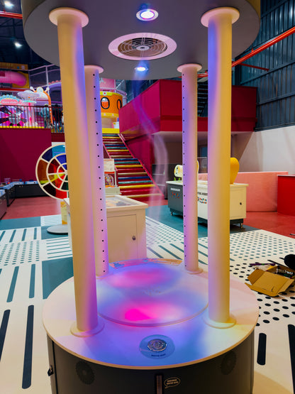 A colorful interactive exhibit with water features and lights in a children's play area.