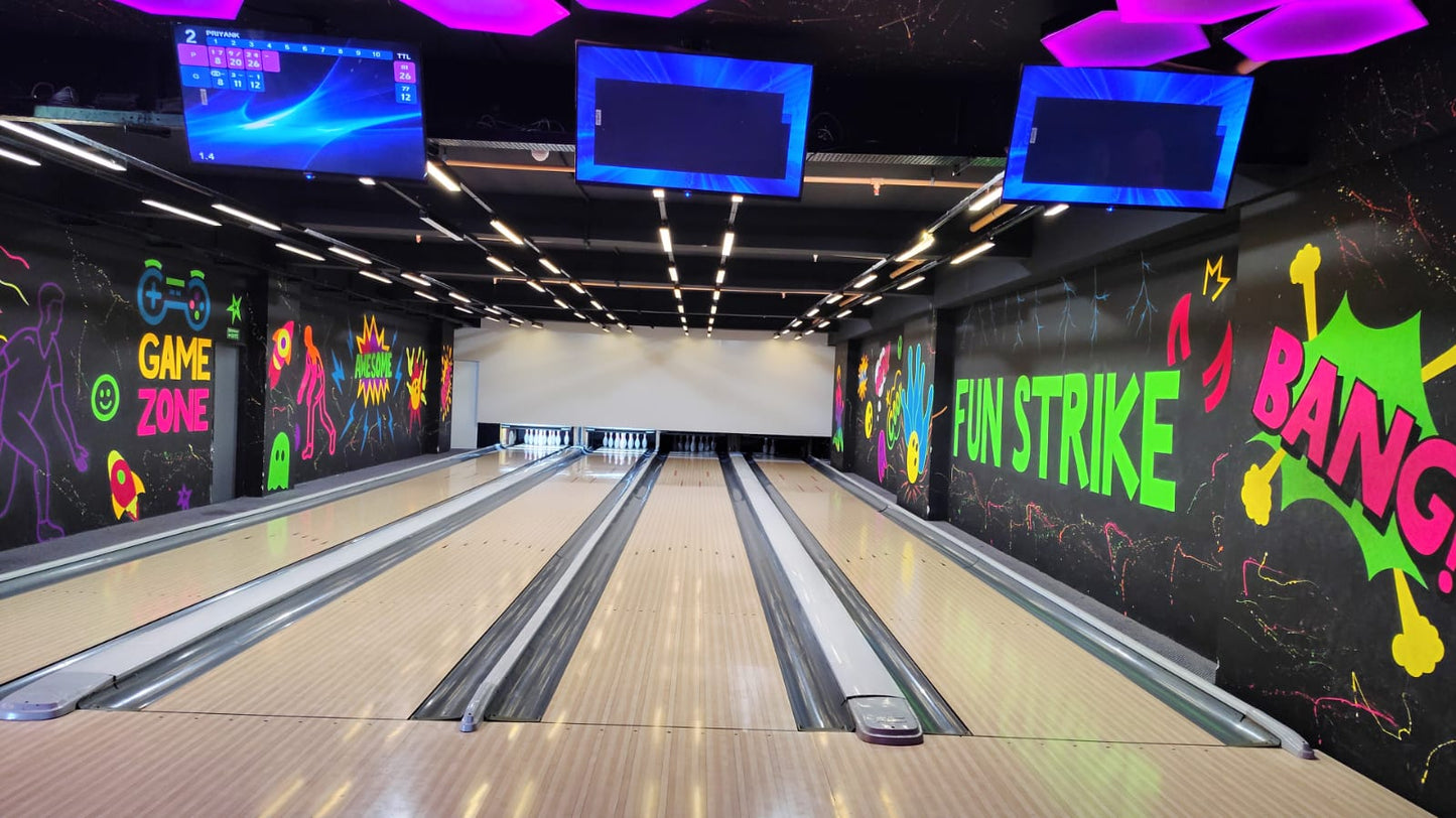 A bowling alley with colorful graffiti and screens showing scores.
