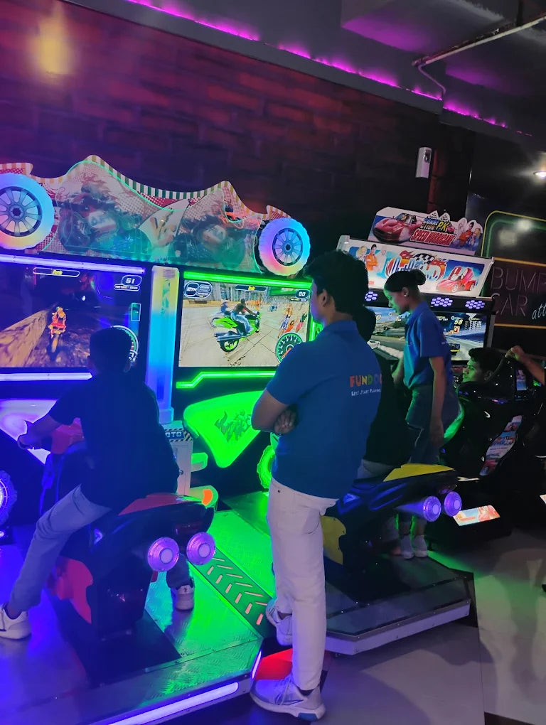 Kids engaged in motorcycle racing arcade games with glowing neon lights inside a vibrant gaming zone