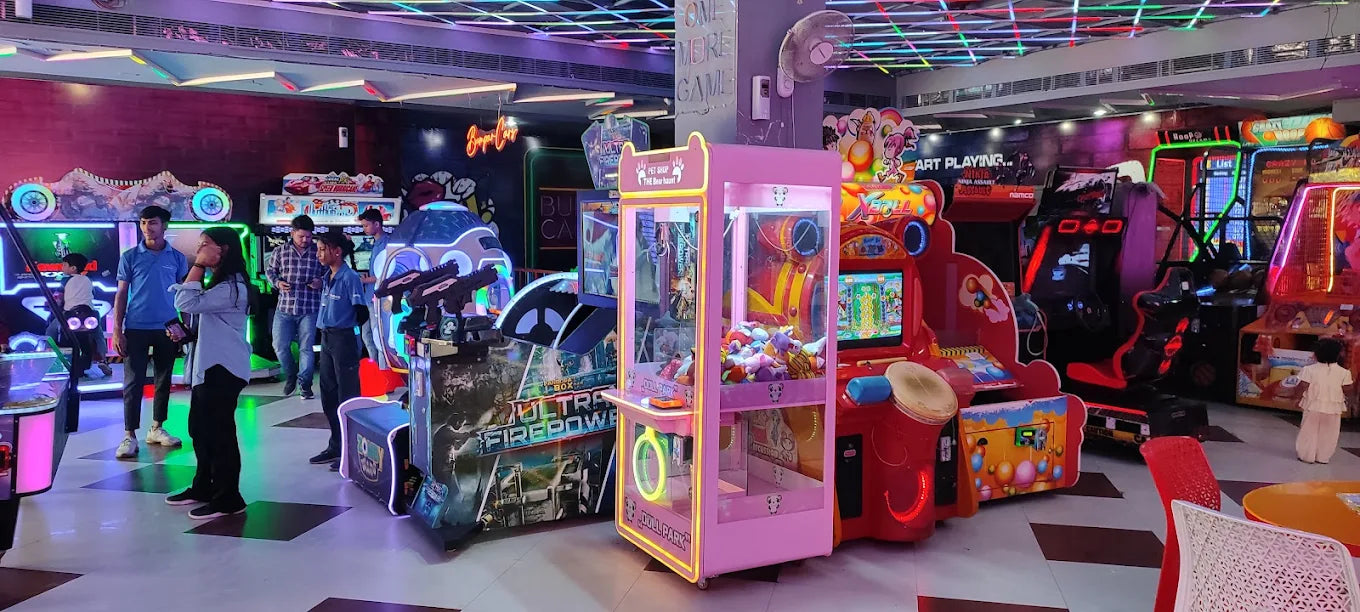 People playing a variety of arcade games in a playzone