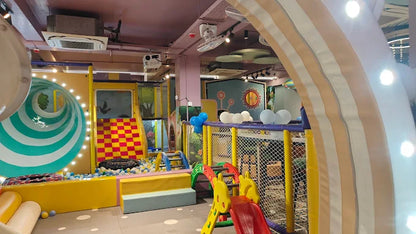Colorful indoor playground with slides and play structures.